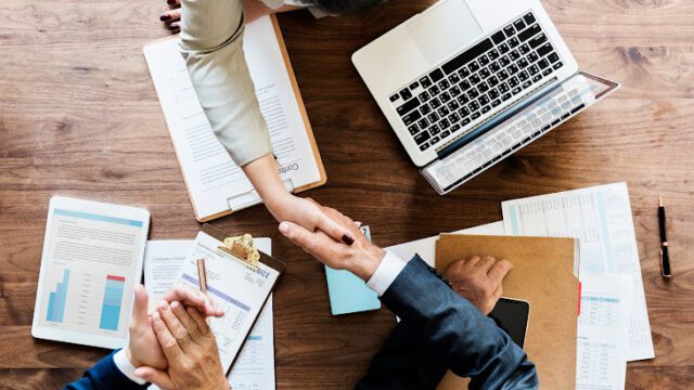 Business people shaking hands together